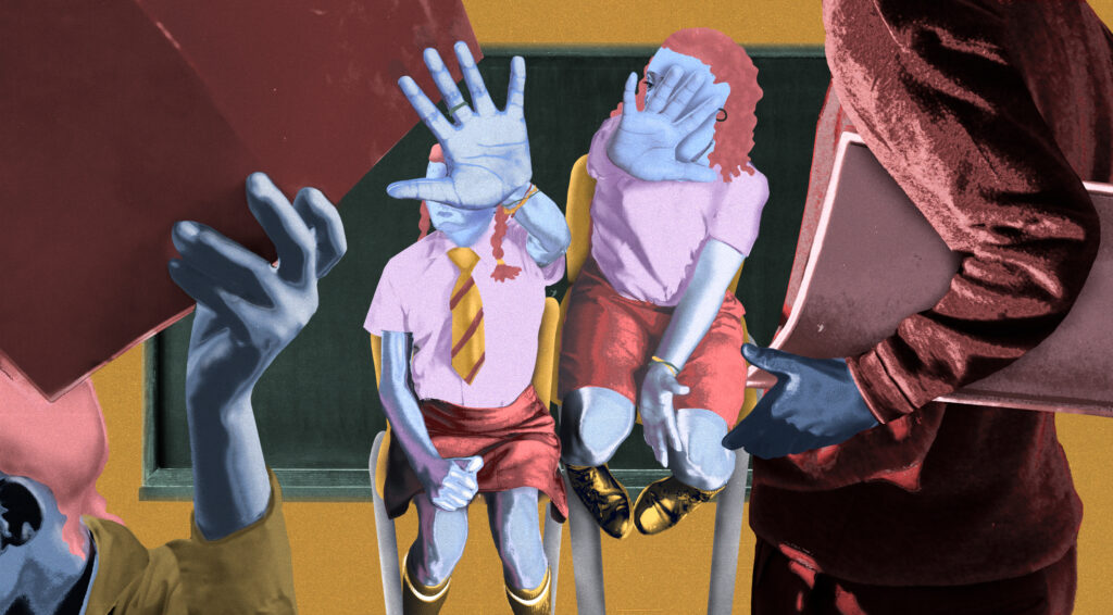 Schoolgirls hold up their hands while teachers face them