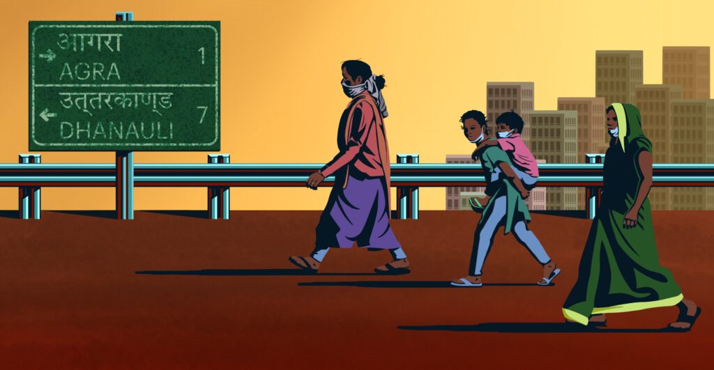 Women and children walk on a highway towards a road sign in India