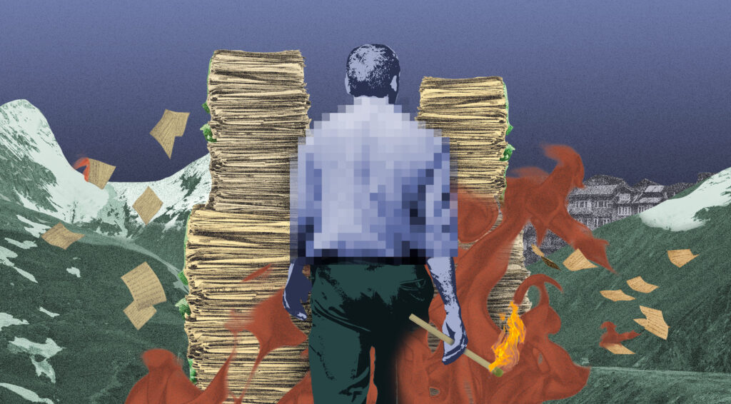 A man with a match in his hands walks towards stacks of documents in a mountainous region (Kashmir)