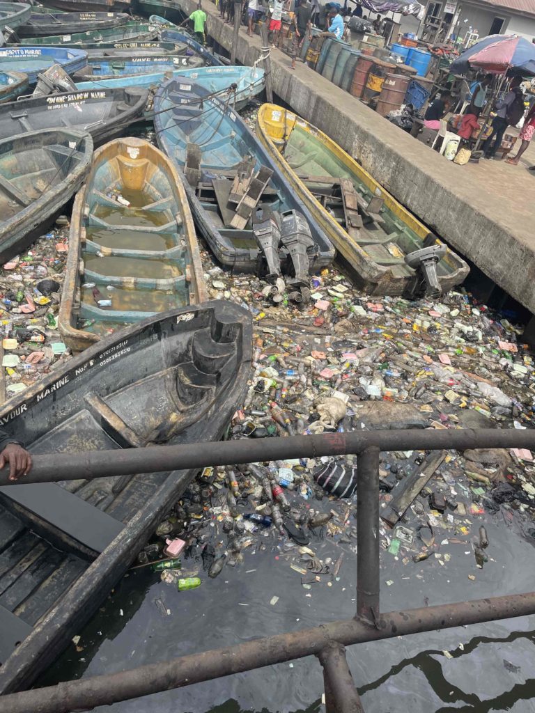 Port water is crowded with trash and boats