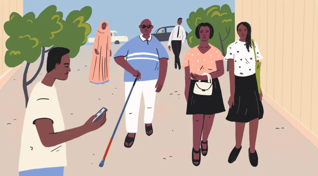 Several people walk down a street in Nigeria, a young man, two women side by side, one man has a walking stick and sunglasses.
