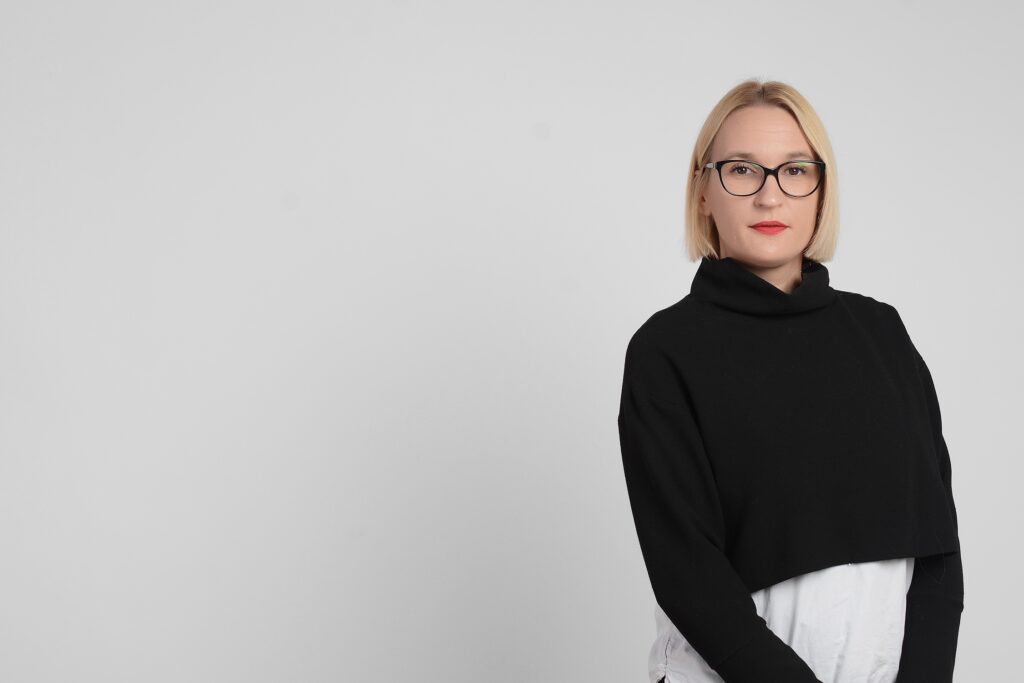 Irena Cvetkovic wears a black sweater, bobbed hair and glasses