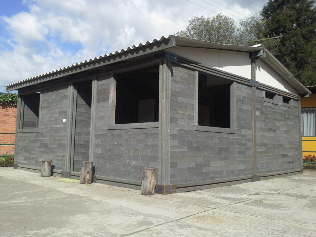 A gray one-story house built with smooth bricks that are actually made of plastic.