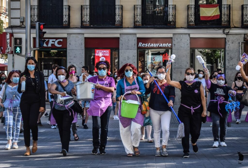 Rafaela Pimentel (center), alongside her compañeras from Territorio Doméstico, performs a catwalk during a demonstration in Madrid on 21 June 2020, calling for the ratification of Convention 189 (C189) and the regularization of migrants with irregular administrative status. Embracing their festive and joyful spirit, they bring music, flash mobs, and costumes to every protest.
