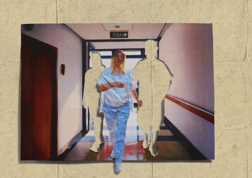 A woman walks into a hospital with two cut out doctors behind her